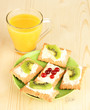 Tasty canapes with cheese and kiwi, cranberry,