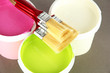 Set for painting: paint pot, brushes on grey background