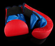 Foto: Small children boxing gloves on black background Small children boxing gloves on black background
