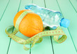 Orange with measuring tape, bottle of water,