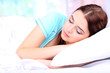 Beautiful young woman sleeping in bed