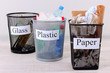 Three buckets of assorted debris on room background