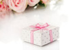 Beautiful gift on flowers background isolated on white