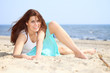young woman on seacoast with shell on sand