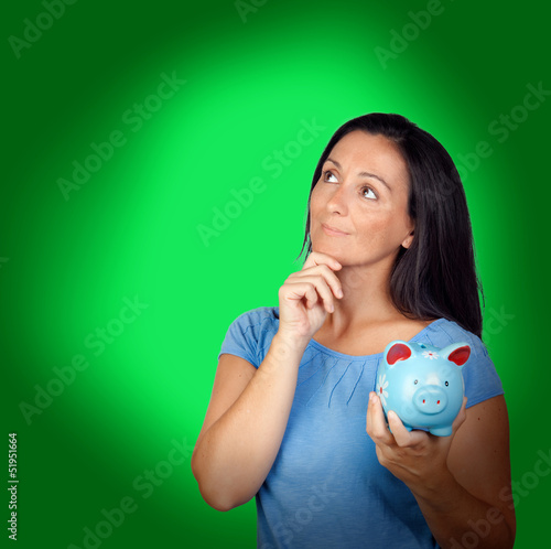 Photo: Pensive woman with a blue money-box Pensive woman with a blue money-box