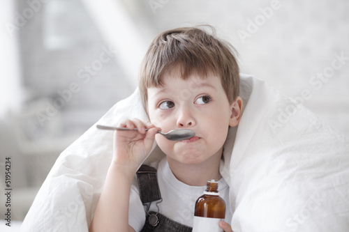 Photo: boy drinking cough syrup boy drinking cough syrup