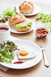 Fried egg on heart-shaped toast with salad for Valentine's Day