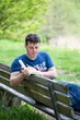 Man sitting on a bench and readindg a book