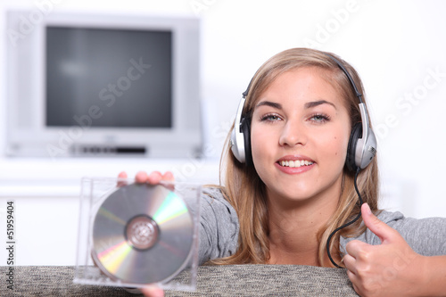 Photo: Young woman holding a CD Young woman holding a CD