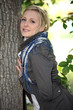 Photo: Woman leaning against tree Woman leaning against tree