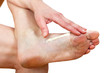 Foto: A woman putting cream on her foot A woman putting cream on her foot