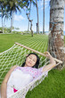 Asian woman sleep in hammock at beach
