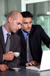 Photo: Businessmen looking at a laptop Businessmen looking at a laptop