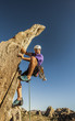 Climber dangles from the edge.