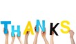 hands holding letters THANKS