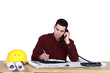 Photo: Architect sat at desk making call Architect sat at desk making call