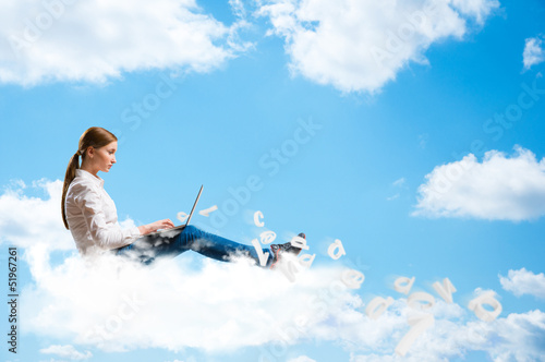 Photo: young girl running in the clouds with a laptop young girl running in the clouds with a laptop