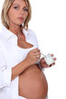 Foto: Pregnant woman eating a yogurt Pregnant woman eating a yogurt