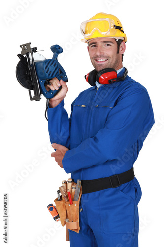 Photo: young blue collar with protective equipment and sander machine young blue collar with protective equipment and sander machine