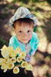 on the nature of the little boy in a blue shirt with a bouquet o
