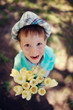 Photo: on the nature of the little boy in a blue shirt with a bouquet o on the nature of the little boy in a blue shirt with a bouquet o
