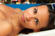 Photo: Pretty young woman relaxed by the pool Pretty young woman relaxed by the pool