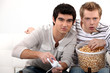 Photo: Young men hooked on a video game Young men hooked on a video game