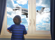 Photo: Boy Looking at Flying Airplane in Room Boy Looking at Flying Airplane in Room