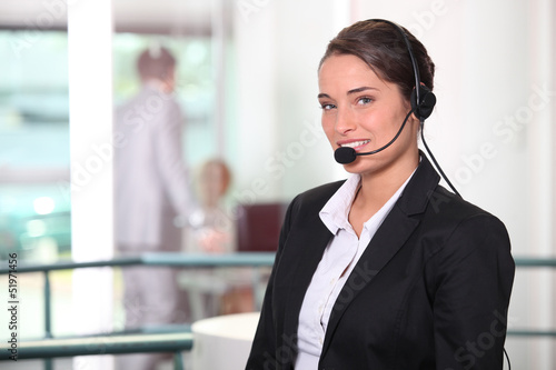 Photo: Woman smiling with headset Woman smiling with headset