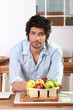 Photo: Man in kitchen leaning on countertop Man in kitchen leaning on countertop