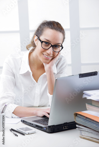 Photo: Business woman portrait in an office Business woman portrait in an office