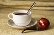 A cup of black coffee with a pipe in high resolution