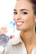 Photo: Young woman drinking water, isolated over white Young woman drinking water, isolated over white