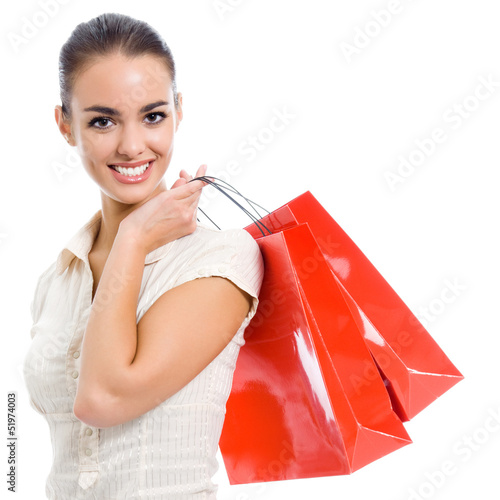 Photo: Young happy woman with shopping bags, isolated Young happy woman with shopping bags, isolated
