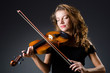 Attractive woman with cello in studio