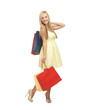 woman with shopping bags in dress and high heels
