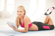 woman lying on the floor with tablet pc
