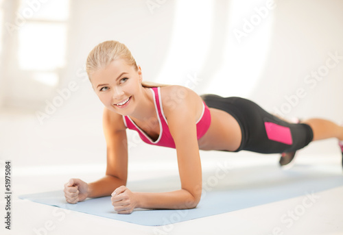 Photo: sporty woman doing exercise on the floor sporty woman doing exercise on the floor