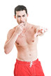 Male lifeguard blowing his whistle pointing