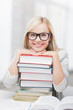 student with stack of books