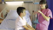 Female Doctor Examining Boy On Hospital Bed