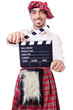 Scotsman with movie board on white