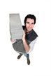 Photo: Man carrying breeze block Man carrying breeze block