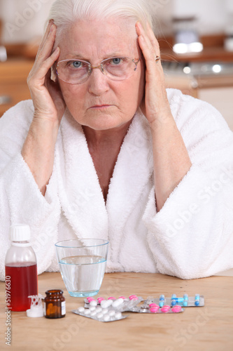 Photo: Bitter woman in front of her medication Bitter woman in front of her medication