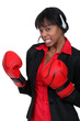 Photo: Businesswoman wearing a headset and boxing gloves Businesswoman wearing a headset and boxing gloves