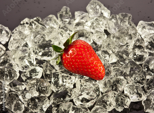 Photo: strawberry on black background. strawberries with ice cubes on strawberry on black background. strawberries with ice cubes on