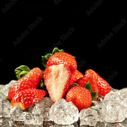 Photo: strawberry on black background. strawberries with ice cubes on strawberry on black background. strawberries with ice cubes on