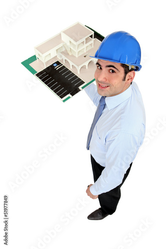 Photo: Man holding model housing Man holding model housing