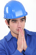 Workman holding his hands together