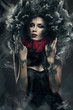 Foto: mysterious woman in black hood in dust mysterious woman in black hood in dust